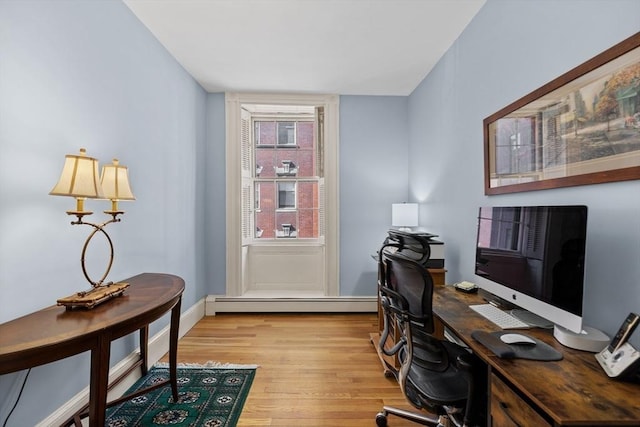 office area featuring light wood-style flooring, baseboards, and baseboard heating