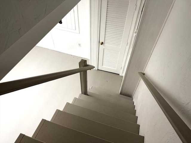 stairway featuring concrete floors