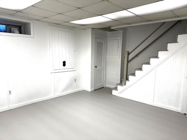 basement with a paneled ceiling