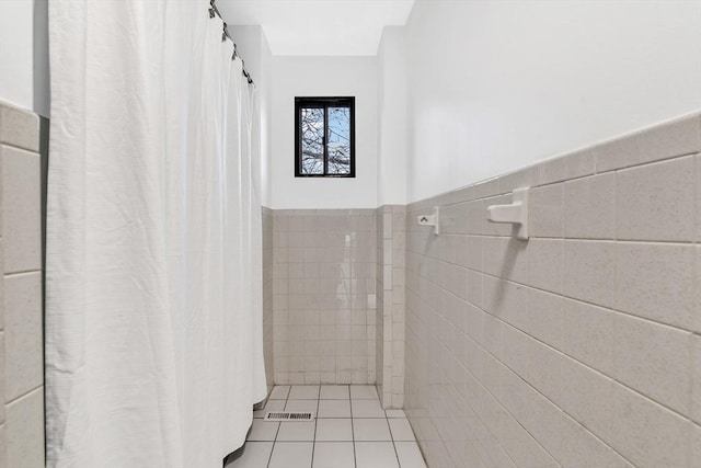 bathroom featuring tile patterned floors and tile walls