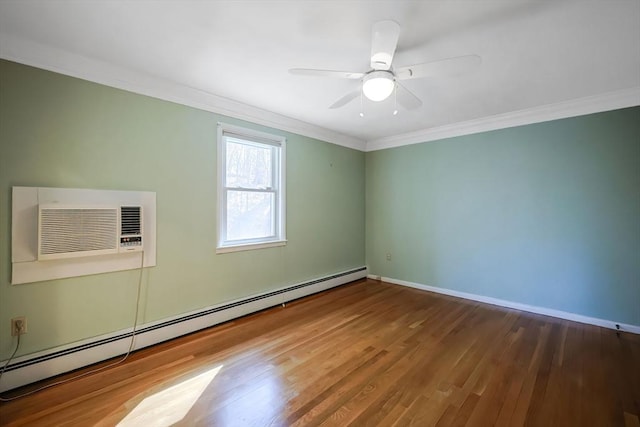 empty room with ornamental molding, a baseboard heating unit, a wall unit AC, and wood finished floors