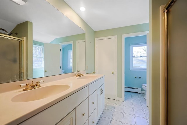 bathroom with baseboard heating, plenty of natural light, and a sink