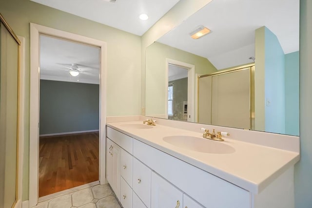 bathroom featuring a sink, an enclosed shower, double vanity, and tile patterned flooring