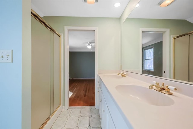 full bathroom featuring a shower stall, double vanity, tile patterned floors, and a sink