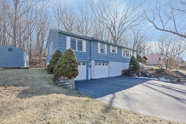 exterior space featuring an outbuilding, a shed, an attached garage, stucco siding, and aphalt driveway