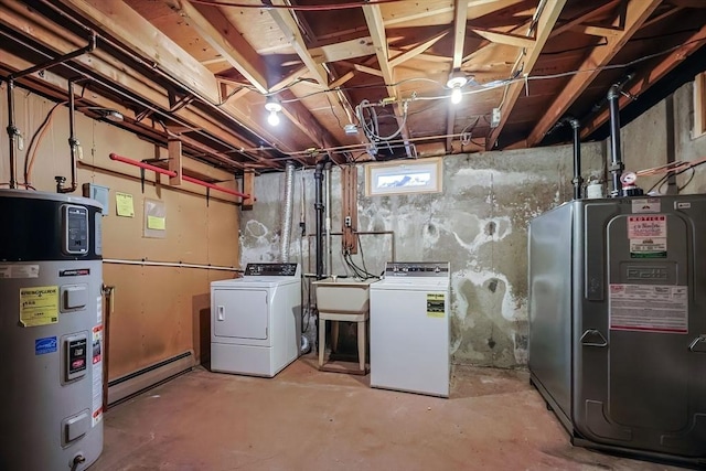 basement featuring washer and dryer, a baseboard heating unit, a sink, fridge, and hybrid water heater