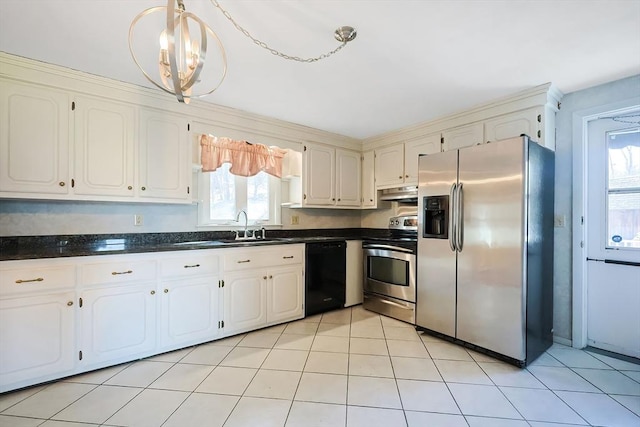 kitchen with dark countertops, under cabinet range hood, light tile patterned floors, stainless steel appliances, and a sink