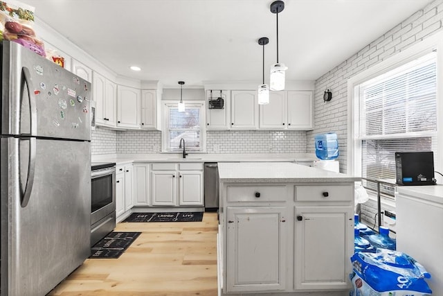 kitchen featuring white cabinetry, appliances with stainless steel finishes, and a sink