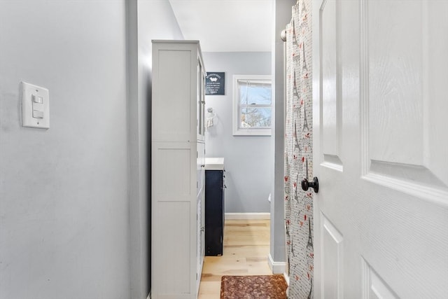 bathroom featuring baseboards and wood finished floors