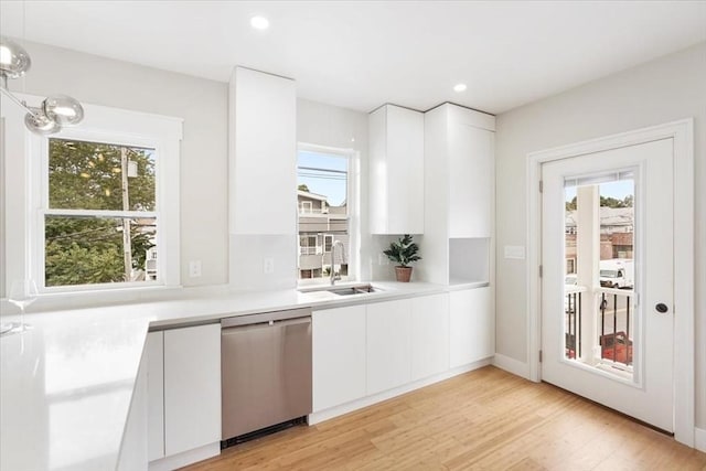 kitchen featuring sink, white cabinetry, and dishwasher