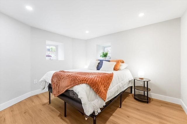 bedroom featuring light hardwood / wood-style flooring and multiple windows