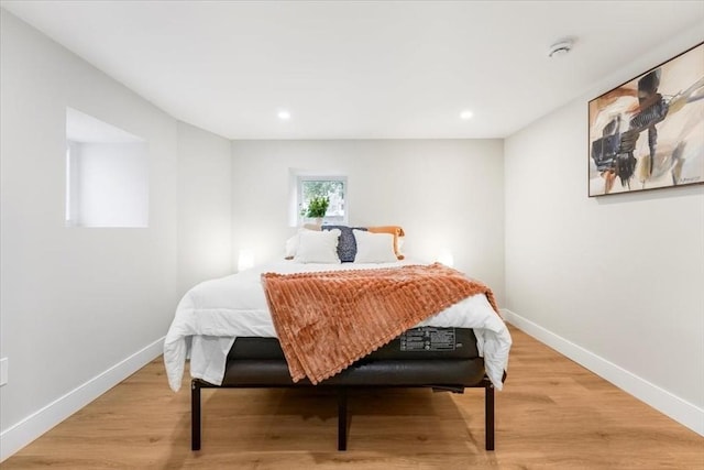 bedroom with hardwood / wood-style flooring