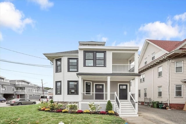 view of front of home with a porch and a front lawn