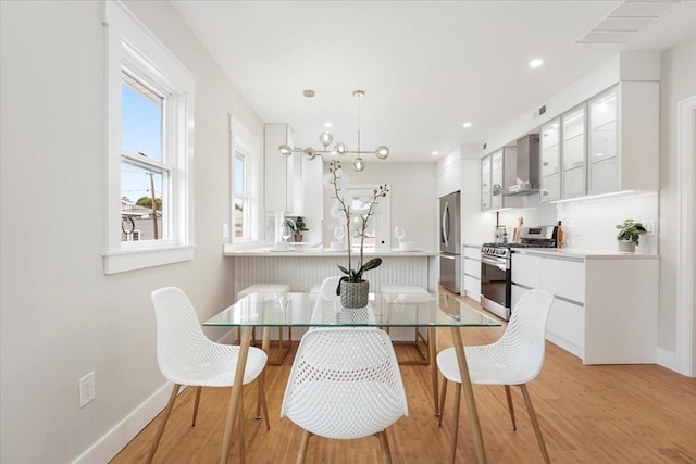 dining space with light hardwood / wood-style floors