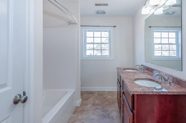 bathroom with a sink, visible vents, and a healthy amount of sunlight