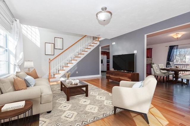 living area featuring stairs and wood finished floors