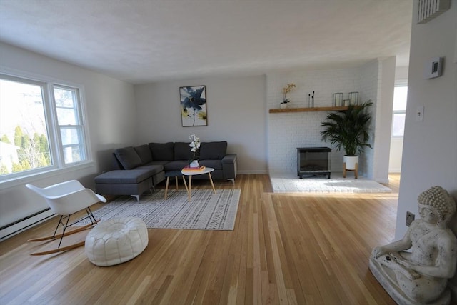 living room with a fireplace and light hardwood / wood-style floors