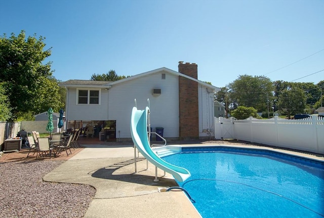 view of swimming pool featuring a patio and a water slide