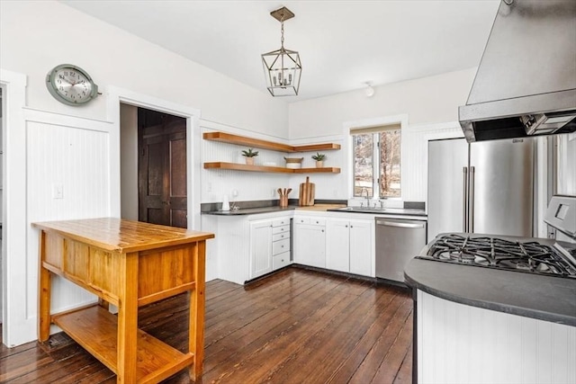 kitchen with a sink, open shelves, stainless steel appliances, wall chimney exhaust hood, and dark wood-style flooring