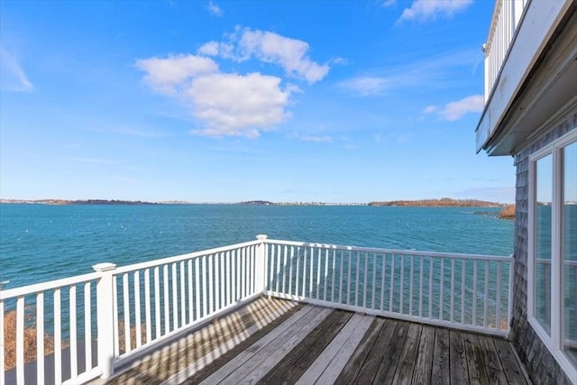 view of dock featuring a balcony and a water view