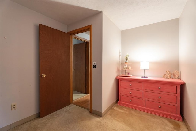 hallway featuring light carpet