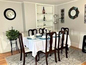 dining room with crown molding and hardwood / wood-style floors