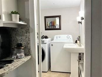 clothes washing area featuring washer and dryer