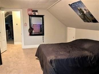 carpeted bedroom with lofted ceiling