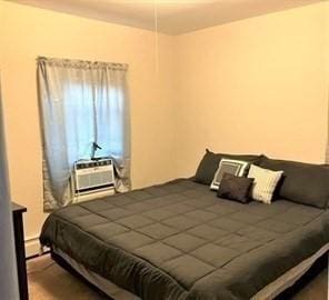 bedroom featuring an AC wall unit