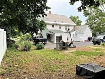 back of house with a lawn