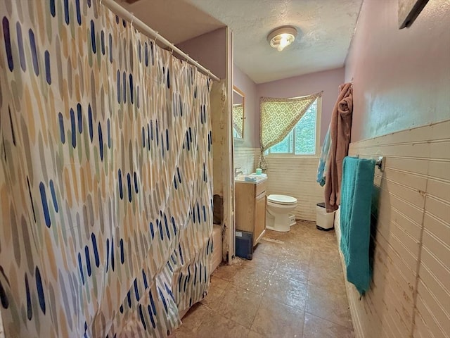 46 Barry Rd, Worcester, MA 01609 - full bathroom featuring tile walls, a shower with shower curtain, vanity, a wainscoted wall, and a textured ceiling