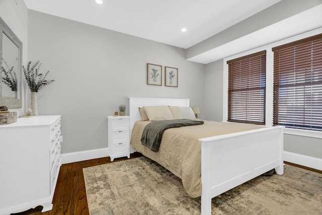 bedroom with dark wood-type flooring