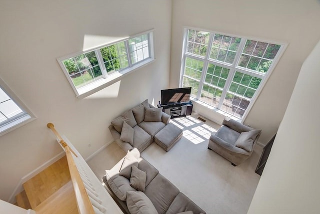 living room with a towering ceiling and a wealth of natural light