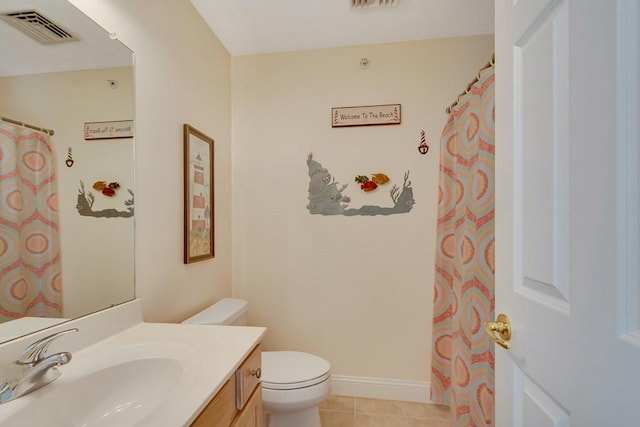 bathroom featuring vanity, tile patterned floors, and toilet