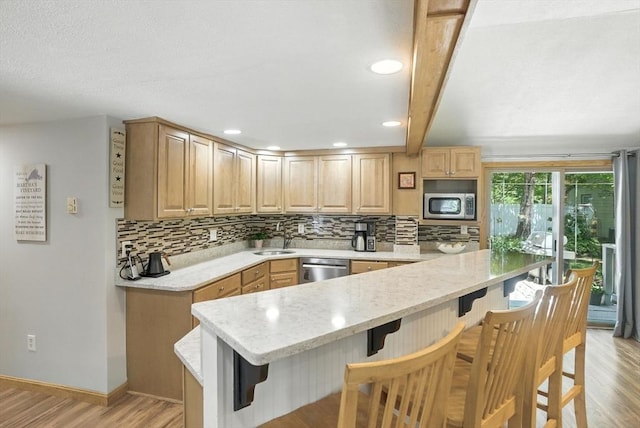 6 Hillcrest Dr, Hopkinton, MA 01748 - kitchen featuring appliances with stainless steel finishes, tasteful backsplash, a breakfast bar area, beam ceiling, and recessed lighting