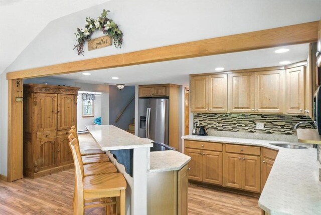 6 Hillcrest Dr, Hopkinton, MA 01748 - kitchen with stainless steel refrigerator with ice dispenser, a breakfast bar, light wood finished floors, backsplash, and a center island