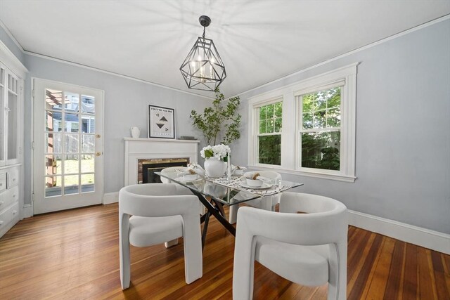 40 S Crescent Circuit, Boston, MA 02135 - dining space with ornamental molding, wood finished floors, baseboards, a brick fireplace, and a chandelier