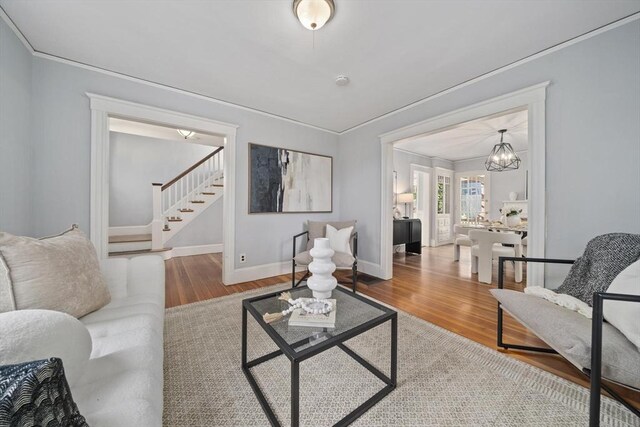 40 S Crescent Circuit, Boston, MA 02135 - living room featuring stairs, wood finished floors, a chandelier, crown molding, and baseboards