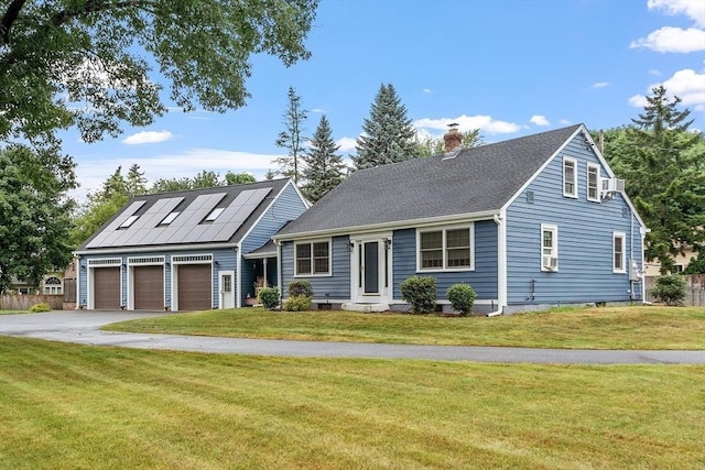 view of front facade with a garage, a front lawn, and solar panels