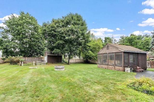 view of yard with an outbuilding and a fire pit