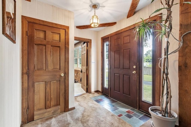 entryway featuring beamed ceiling