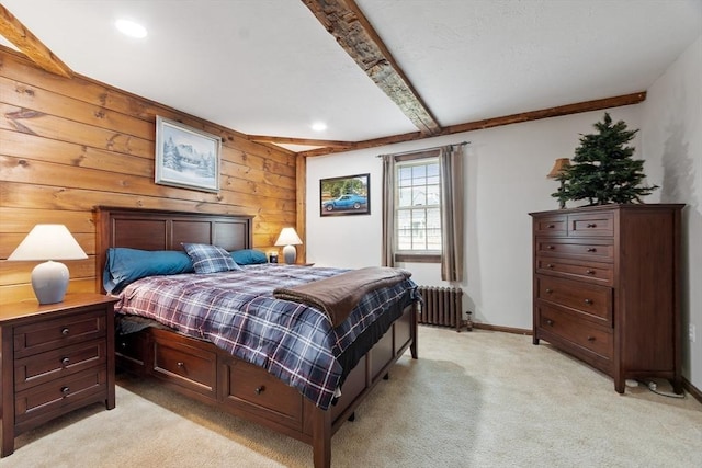 carpeted bedroom featuring beam ceiling, radiator, and wood walls