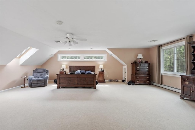 carpeted bedroom featuring a baseboard heating unit, lofted ceiling with skylight, and ceiling fan