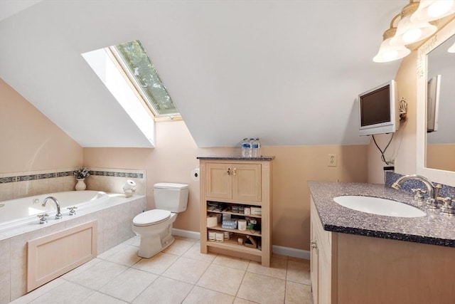 bathroom with vanity, lofted ceiling with skylight, tile patterned floors, and toilet