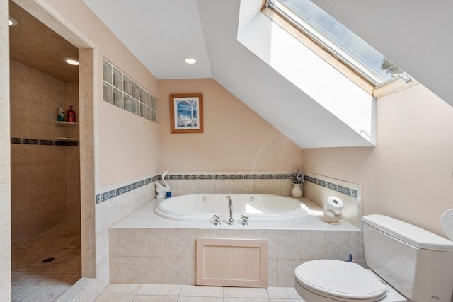 bathroom with tile patterned flooring, vaulted ceiling, independent shower and bath, and toilet