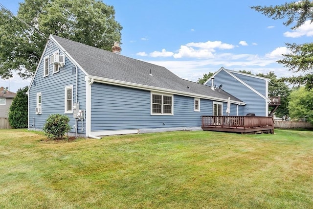 back of house with a wooden deck and a lawn