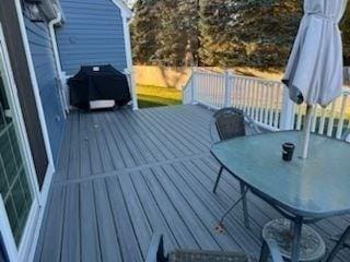 wooden terrace featuring a grill