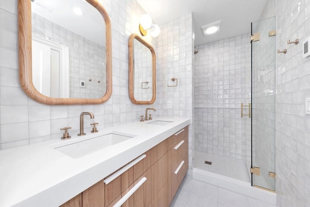 bathroom with a sink, tile patterned floors, and a shower stall