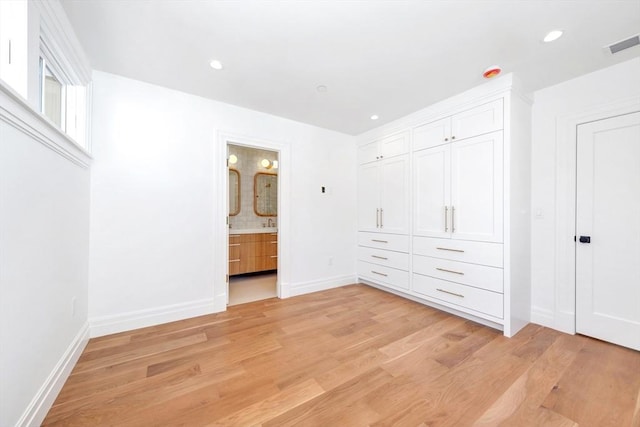 unfurnished bedroom with visible vents, baseboards, recessed lighting, connected bathroom, and light wood-style flooring