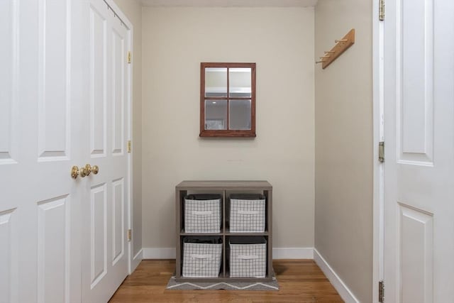 interior space with baseboards and wood finished floors